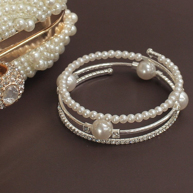 Triple-layered pearl and crystal cuff bracelet in gold and silver — stacked bangle design with rhinestones and faux pearls