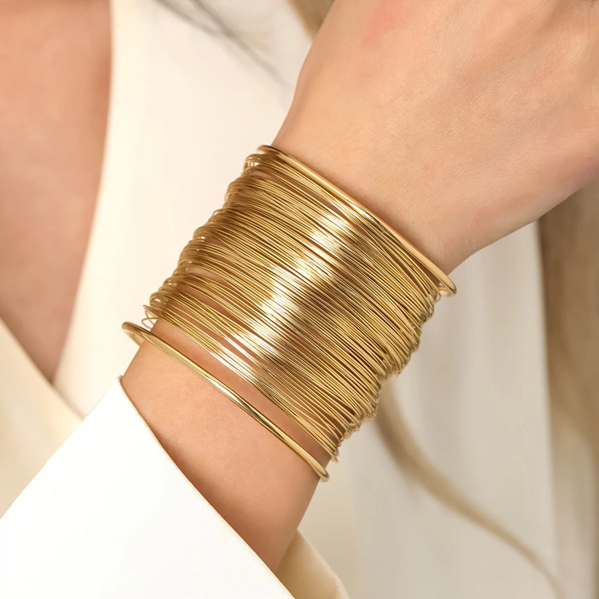 Chunky wire-style open cuff bracelet in gold and silver – layered metallic statement bangle for bold modern looks