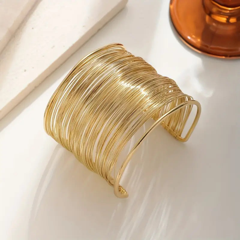 Chunky wire-style open cuff bracelet in gold and silver – layered metallic statement bangle for bold modern looks