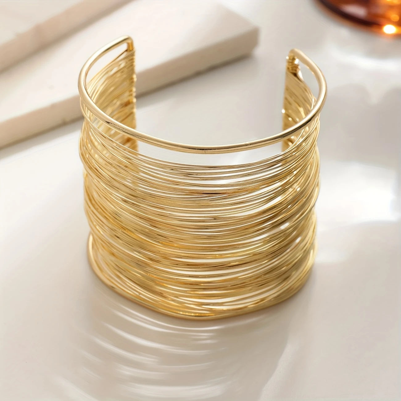 Chunky wire-style open cuff bracelet in gold and silver – layered metallic statement bangle for bold modern looks