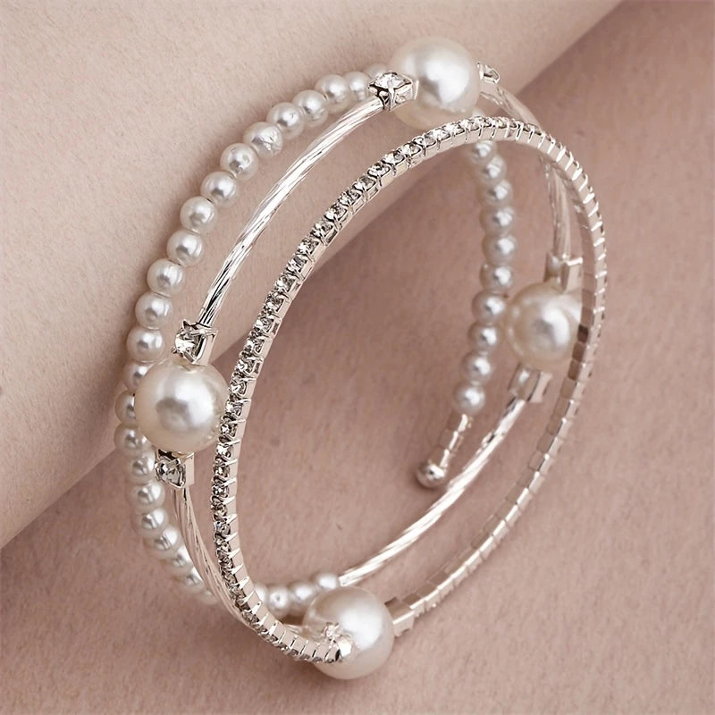 Triple-layered pearl and crystal cuff bracelet in gold and silver — stacked bangle design with rhinestones and faux pearls