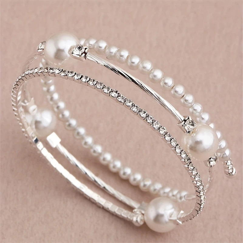 Triple-layered pearl and crystal cuff bracelet in gold and silver — stacked bangle design with rhinestones and faux pearls