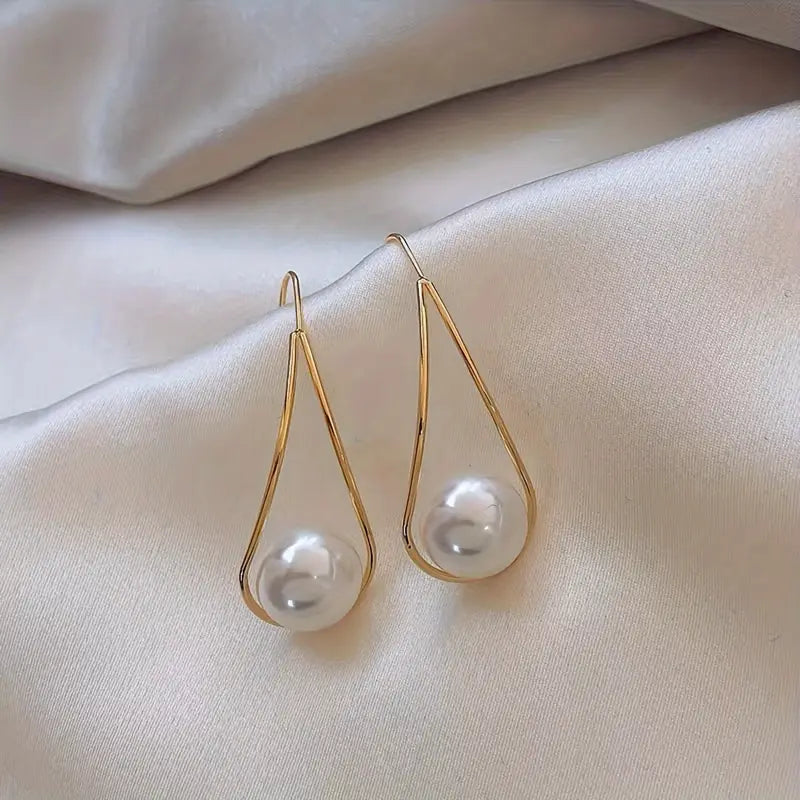 Minimalist teardrop earrings with suspended pearl bead in gold-tone frame – lightweight modern jewelry for women