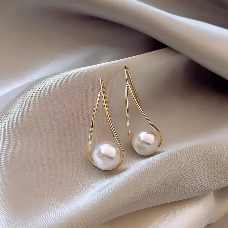 Minimalist teardrop earrings with suspended pearl bead in gold-tone frame – lightweight modern jewelry for women