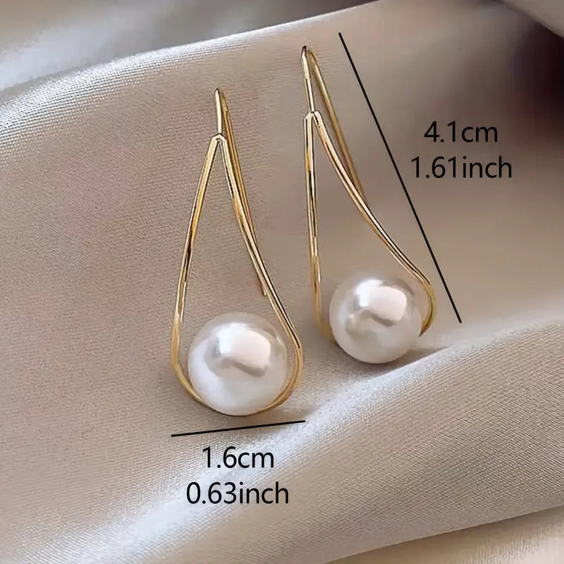 Minimalist teardrop earrings with suspended pearl bead in gold-tone frame – lightweight modern jewelry for women