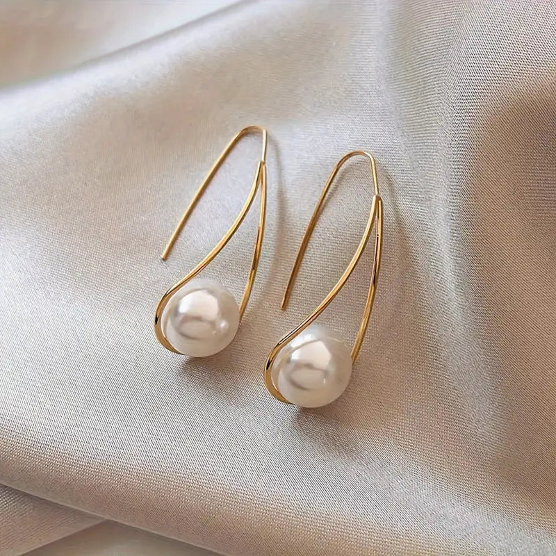 Minimalist teardrop earrings with suspended pearl bead in gold-tone frame – lightweight modern jewelry for women