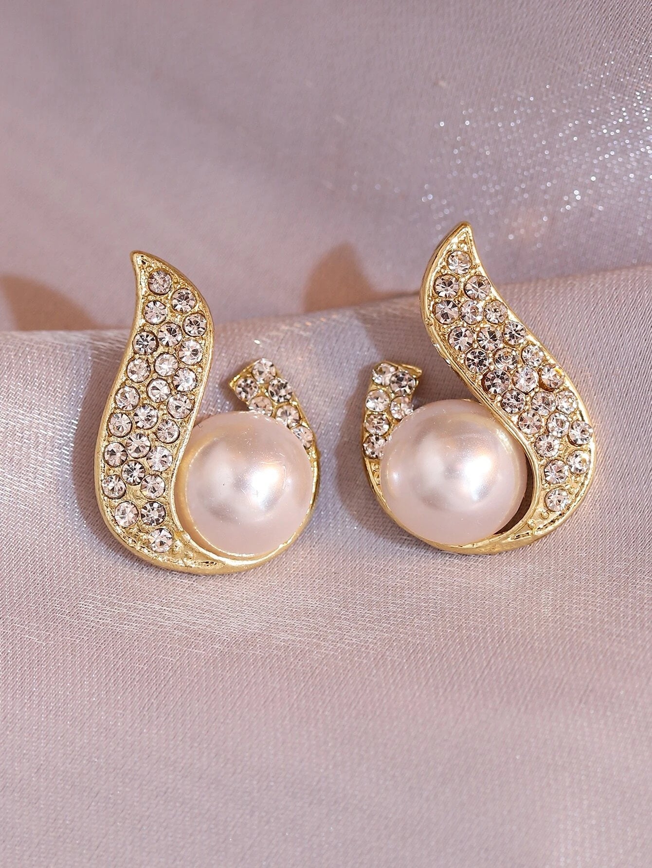 Gold teardrop stud earrings with faux pearl center and encrusted cubic zirconia – elegant modern jewelry for formal or bridal looks
