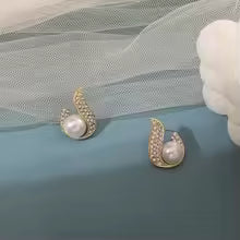 Gold teardrop stud earrings with faux pearl center and encrusted cubic zirconia – elegant modern jewelry for formal or bridal looks