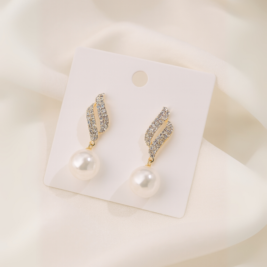 Gold-tone crystal wave earrings with dangling faux pearls – elegant party jewelry for women