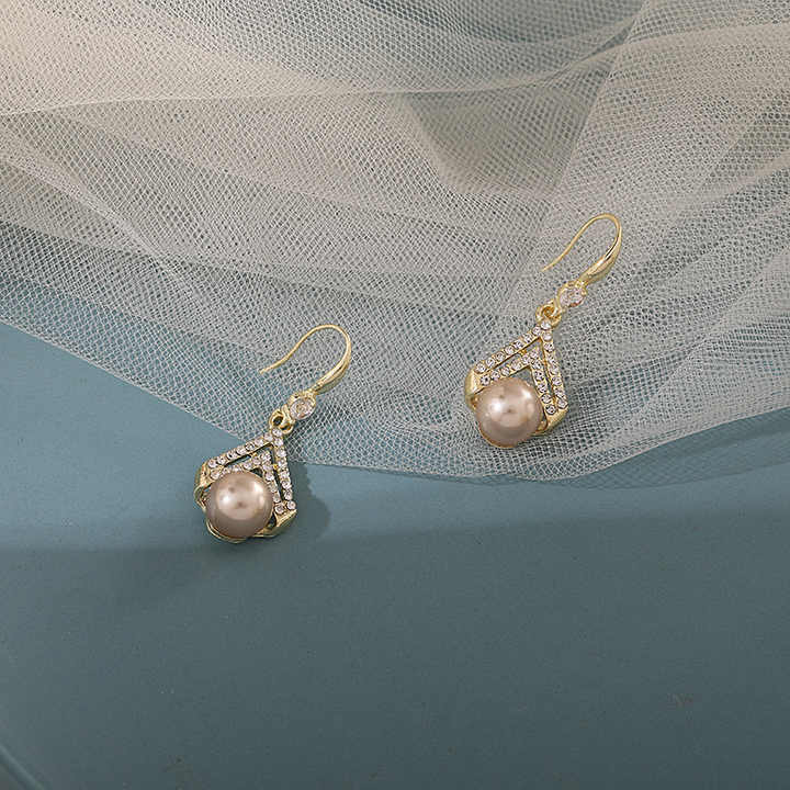 Champagne pearl drop earrings with gold V-shaped crystal detailing – elegant formal jewelry for women