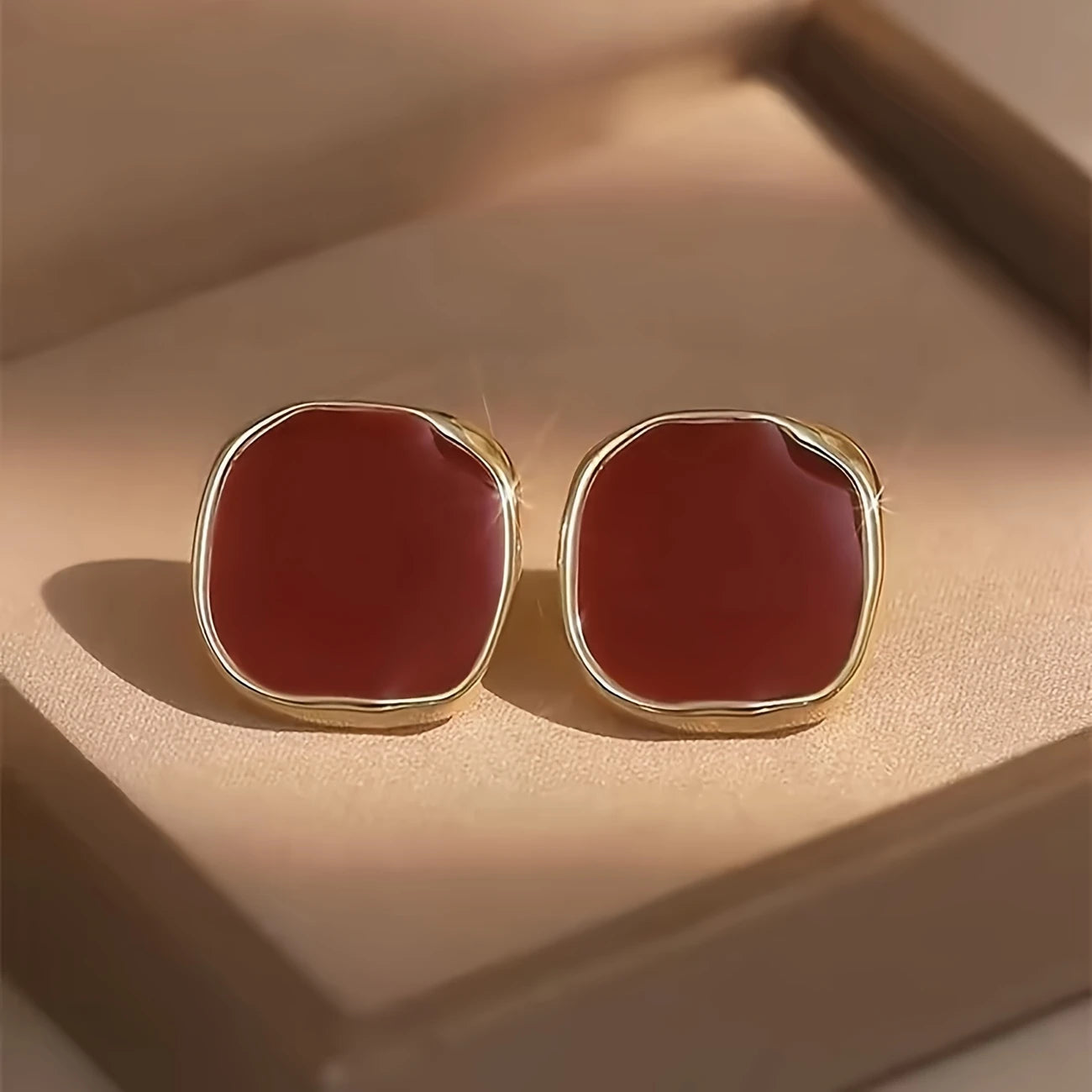 Bold crimson red enamel stud earrings with abstract gold trim – modern geometric jewelry for women