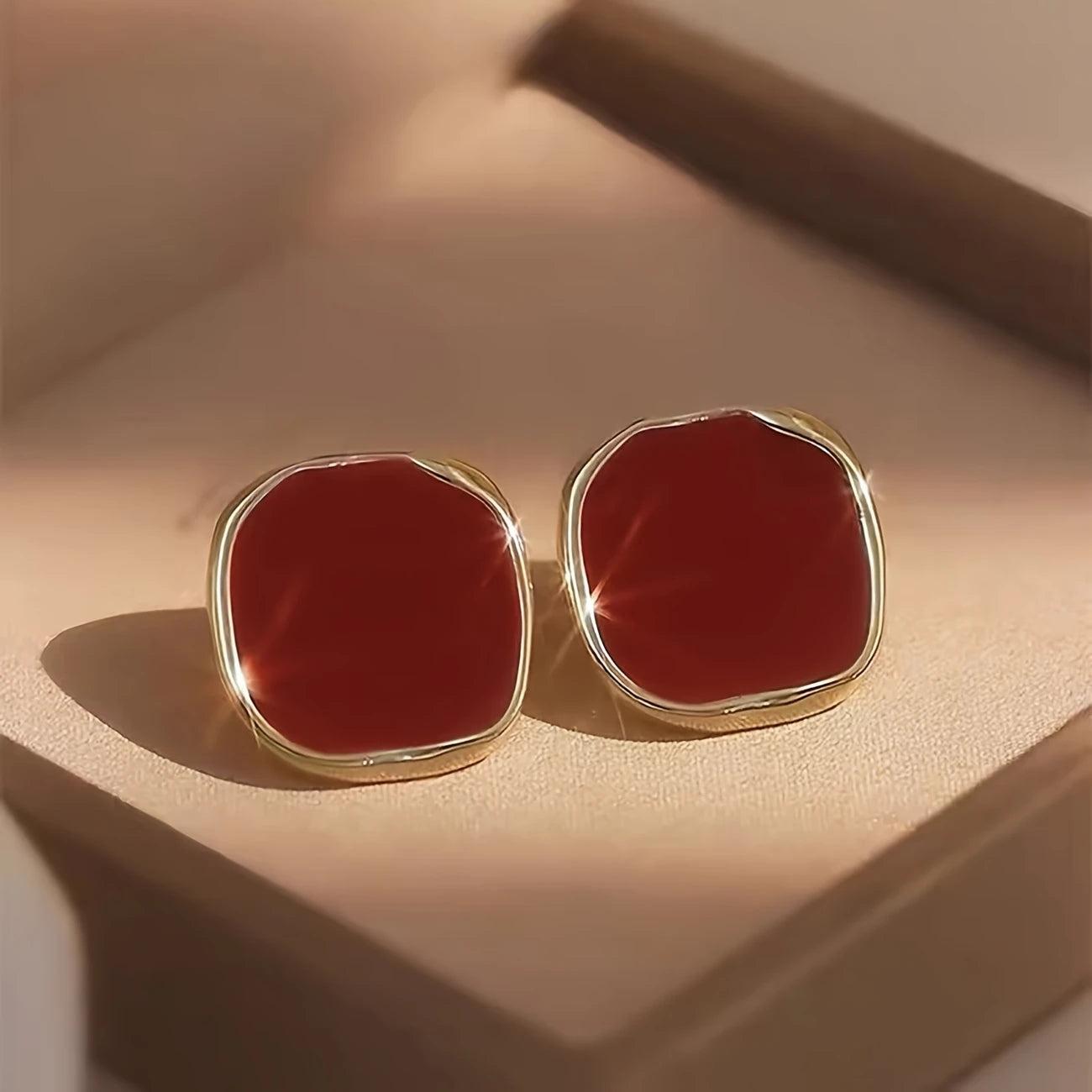 Bold crimson red enamel stud earrings with abstract gold trim – modern geometric jewelry for women