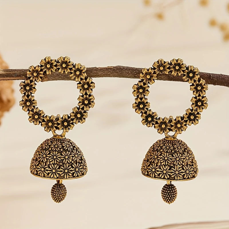 Antique gold floral jhumka earrings with circular flower top and bell-shaped drop – traditional desi jewelry for women