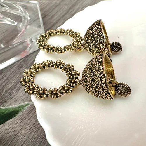 Antique gold floral jhumka earrings with circular flower top and bell-shaped drop – traditional desi jewelry for women