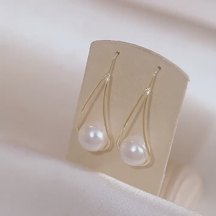 Minimalist teardrop earrings with suspended pearl bead in gold-tone frame – lightweight modern jewelry for women