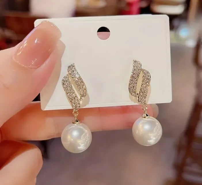 Gold-tone crystal wave earrings with dangling faux pearls – elegant party jewelry for women