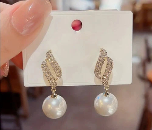 Gold-tone crystal wave earrings with dangling faux pearls – elegant party jewelry for women