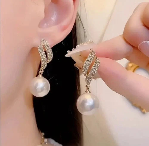 Gold-tone crystal wave earrings with dangling faux pearls – elegant party jewelry for women